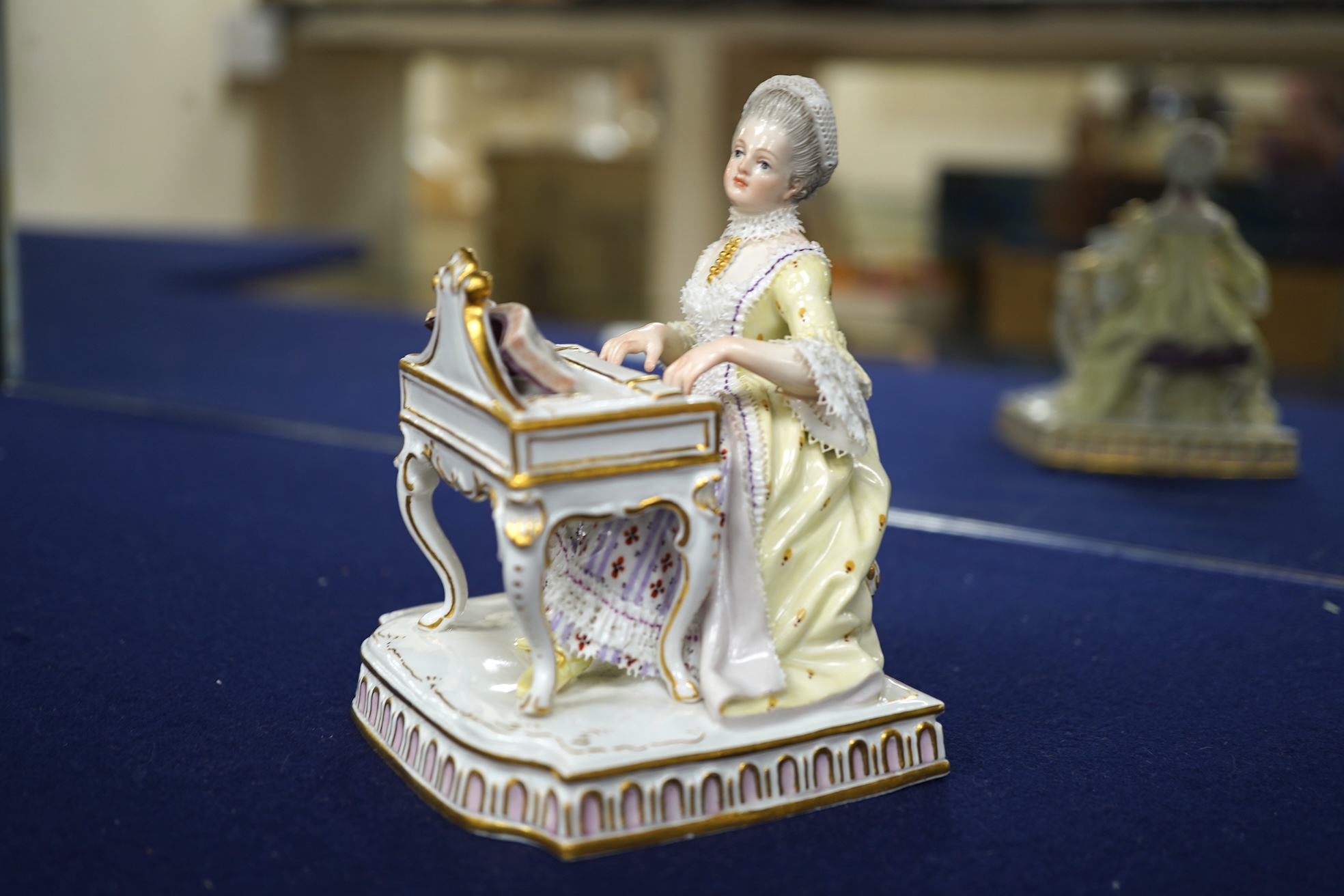 A pair of 19th century Meissen figures of a girl holding a shell and a boy holding a book, in size model number 628, tallest 13cm
